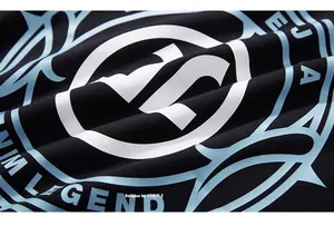 Detailed close-up of high-quality black knit cotton fabric with white and blue M LEGEND print