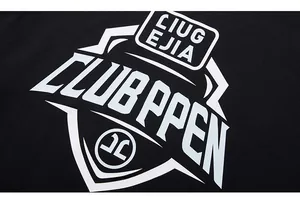 Close-up of white graphic logo print on black cotton long-sleeve street style t-shirt
