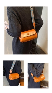 Dettaglio borsa vintage in pelle marrone con ampia tracolla decorata con motivi etnici colorati