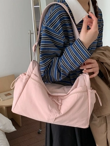 Light pink minimalist nylon tote bag with multiple zip pockets and adjustable strap