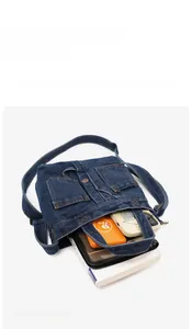 Deep blue denim crossbody bag interior showing large capacity for books and power bank