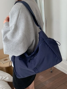 Large navy blue nylon messenger bag for women with multiple zipper pockets and wide strap