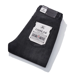 Men's loose straight leg jeans in vintage washed dark grey with dragon logo pocket detail