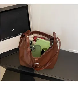 Macro shot of large-capacity brown leather tote bag with spacious interior and beige lining