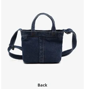 Detailed back view of vintage dark blue denim handbag with classic yellow stitching