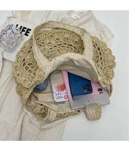 Flat lay of spacious woven straw tote bag with zipper lining and vacation accessories