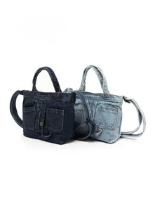 Detail of vintage denim handbags in dark and light blue with dual front flap pockets