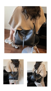 Detailed view of minimalist black tote bag with vintage buckle and premium matte texture