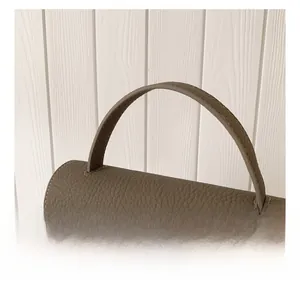 Detail of grey lychee leather texture and hand-stitched handle on vintage square bag