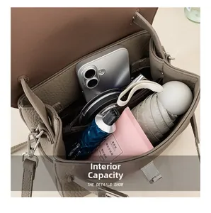 Interior view of small vintage crossbody bag showing capacity for phone and umbrella