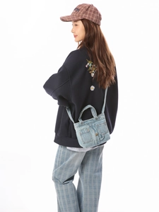 Vintage dark blue denim crossbody bag with daisy embroidery and casual urban styling