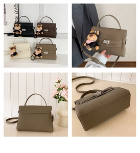 Close-up of litchi pattern leather handbags with metal twist locks and dog pendants