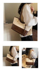Detail of contrast color tote bag with wooden bead charm and long shoulder strap