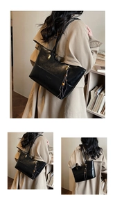 Detail view of black oil wax leather tote bag with gold hardware and tassel decoration