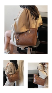 Detailed view of brown leather tote bag with stylish tassel and decorative wood bead charm