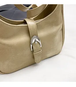 Detailed macro view of light khaki faux leather hobo bag with vintage silver buckle
