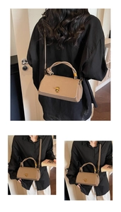 Detailed view of khaki pebbled leather shoulder bag with gold metal buckle and knotted handle
