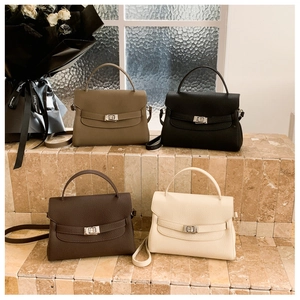 Group of litchi leather handbags in four colors with metal turn-lock and cross straps