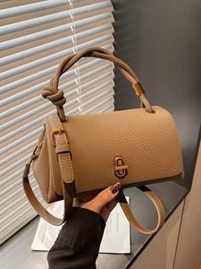 Retro caramel brown lychee leather handbag with braided handle and gold buckle