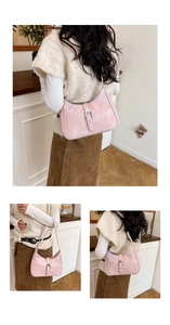 Detail of pink hobo bag with textured leather and large silver metallic vintage buckle