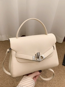 Retro cream-white lychee grain handbag with top handle and crossbody strap in studio