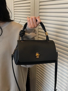 Chic black litchi pattern leather handbag with knotted handle and golden swivel lock