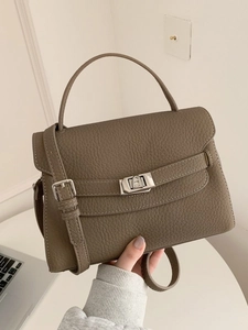 Brown lychee leather handbag with silver twist lock and adjustable crossbody strap