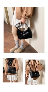 Detail view of black leather hobo bag with silver buckle and zipper closure