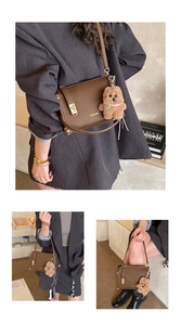 Detailed views of brown lychee leather baguette bag with cute plush bear charm decoration
