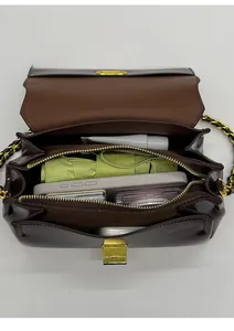 Top view of multi-compartment interior for brown crossbody bag with gold chain strap