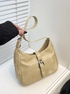 Minimalist beige hobo bag in distressed leather with large silver metal buckle detail