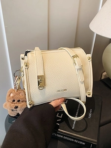 Structured cream leather crossbody bag with gold rivets and cute puppy charm