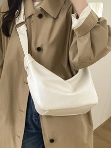 Minimalist cream white leather hobo bag with knotted shoulder strap for daily commuting
