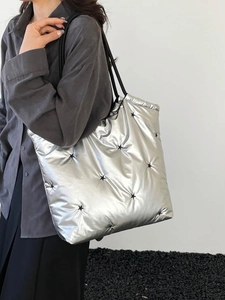 Quilted silver metallic tote bag with black star patterns and slim straps for women