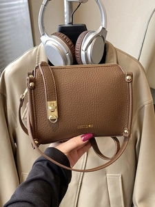Dark brown lychee pattern leather crossbody bag with gold metal lock and shoulder strap