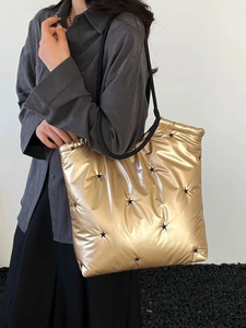 Quilted gold tote bag with black stars and drawstring top for casual large capacity use
