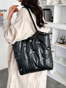 Quilted nylon tote backpack in black featuring golden star studs and a large capacity