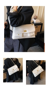 Detailed view of white quilted leather bag with gold twist lock and dual front pockets