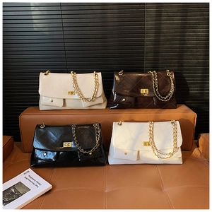 Detail showing various colors of quilted chain tote bags with gold metal clasps