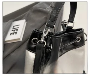 Detailed close-up of silver bucket bag with high-quality hardware and drawstring closure