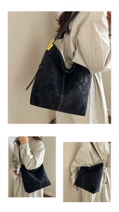 Detail of vintage black tote bag featuring white contrast stitching and gold metal hardware