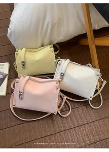 Detailed view of three vintage-style Morandi color bags with pleated leather and silver hardware