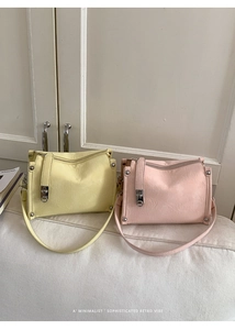 Minimalist retro baguette bags in pastel pink and yellow with vintage cracked leather texture