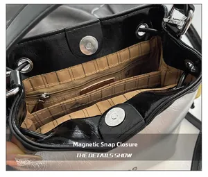 Detail showing the magnetic closure and internal compartments of this black bucket bag