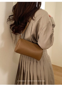 Rear view of brown lychee texture leather shoulder bag shown on a model
