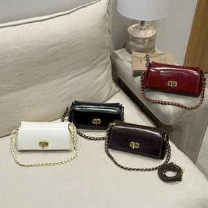 Detail of four glossy leather crossbody bags with metal twist locks and chain straps