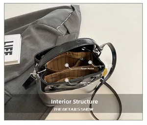 Interior view of bucket bag showing main pocket, zipper bag, and phone slot
