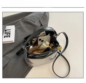 Interior view showing the large capacity and pockets of the silver and black bucket bag