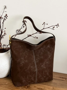 Large dark brown suede tote bag with white contrast stitching and gold hardware