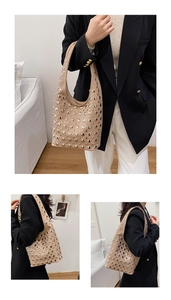 Close-up of beige punk style underarm bag with silver rivet studs and modern leather texture